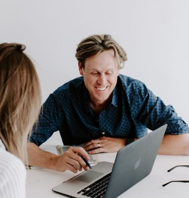 Man and woman looking at a laptop